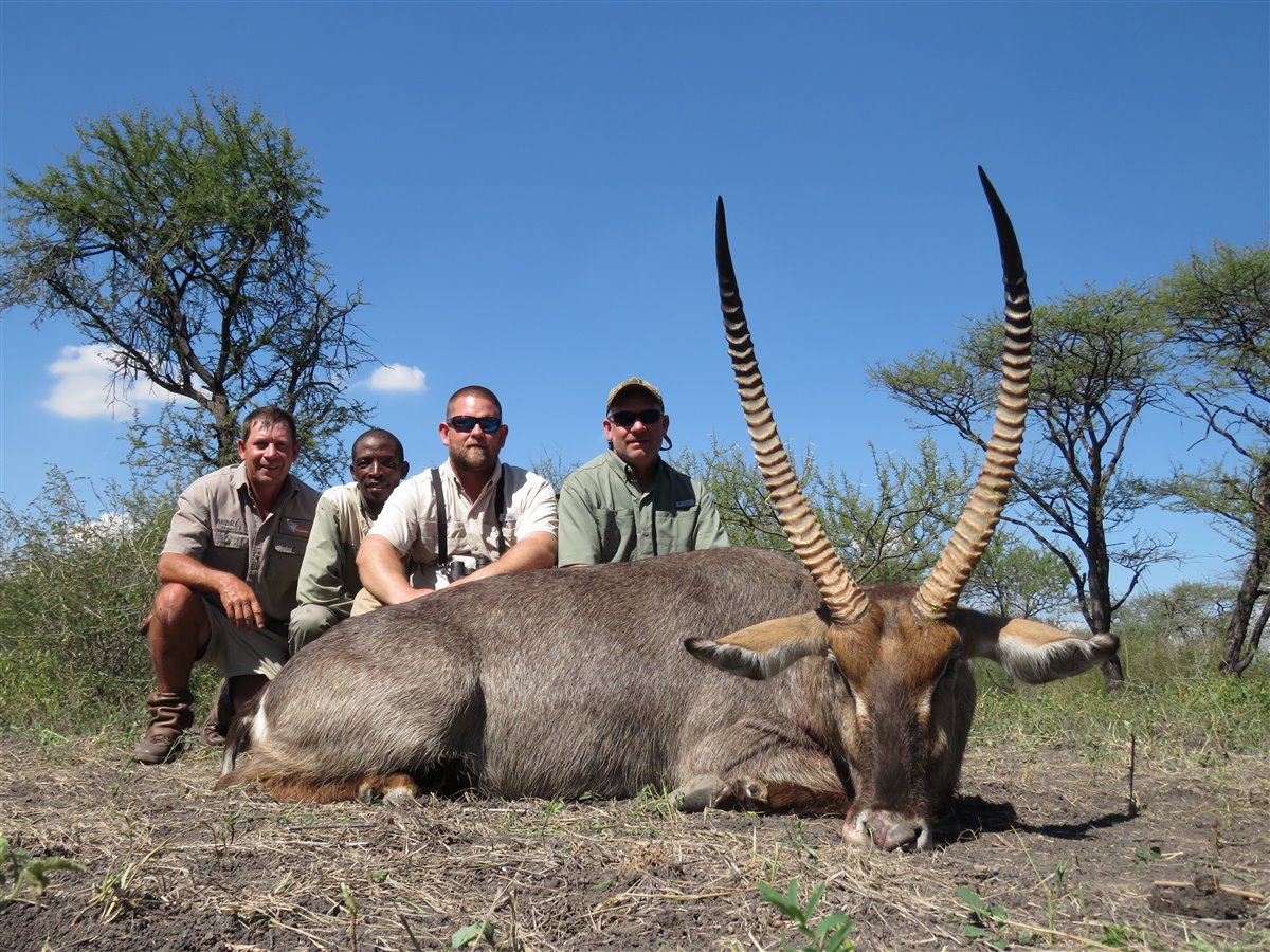 Hunting party with professional hunter, tracker, and Waterbuck trophy at Tolile Lodge