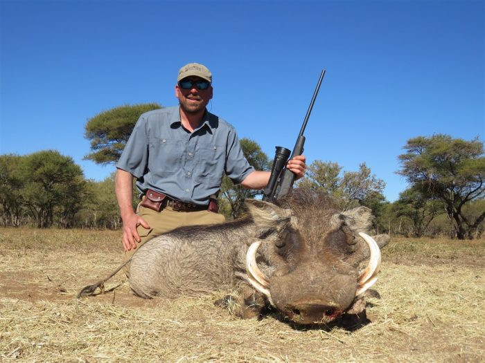 Hunter with a warthog at Tolilé Lodge