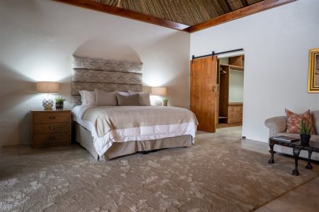 Guest suite bedroom with dressing area at Tolile Lodge