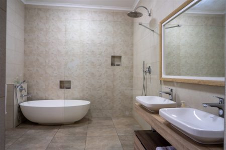 En-suite bathroom with a freestanding bath and double vanity at Tolile Lodge