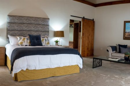 Guest suite bedroom with lounge area at Tolile Lodge